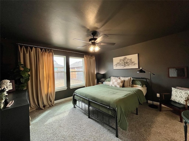 bedroom featuring a ceiling fan, baseboards, and carpet flooring