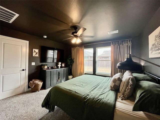 carpeted bedroom featuring visible vents and a ceiling fan