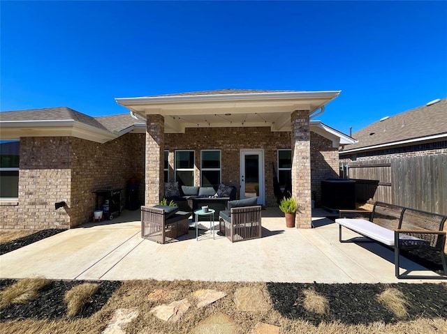 view of patio with fence and outdoor lounge area