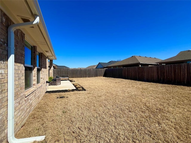 view of yard featuring a fenced backyard and a patio