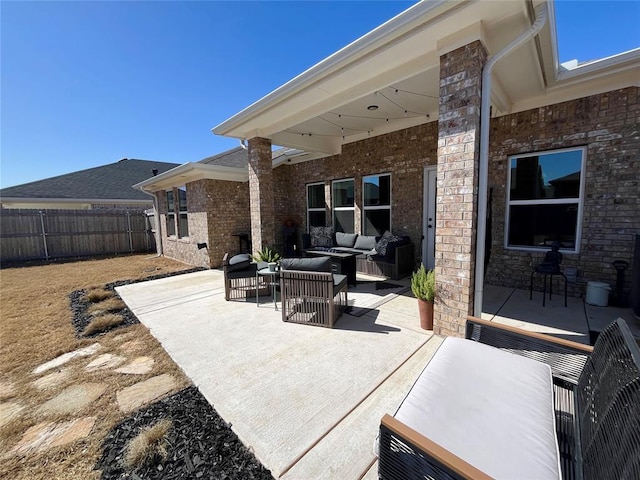 view of patio with outdoor lounge area and fence