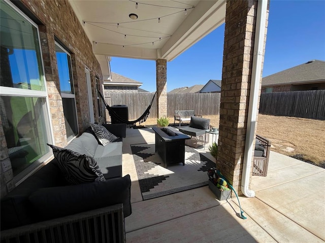 view of patio with a fenced backyard and an outdoor living space with a fire pit