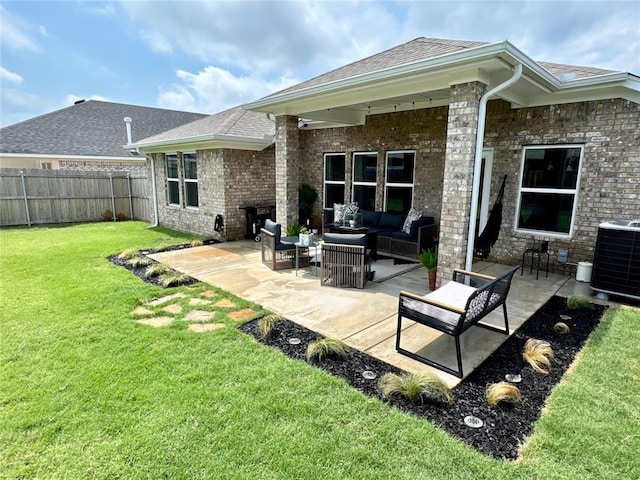 rear view of property with an outdoor hangout area, a yard, a patio, and fence