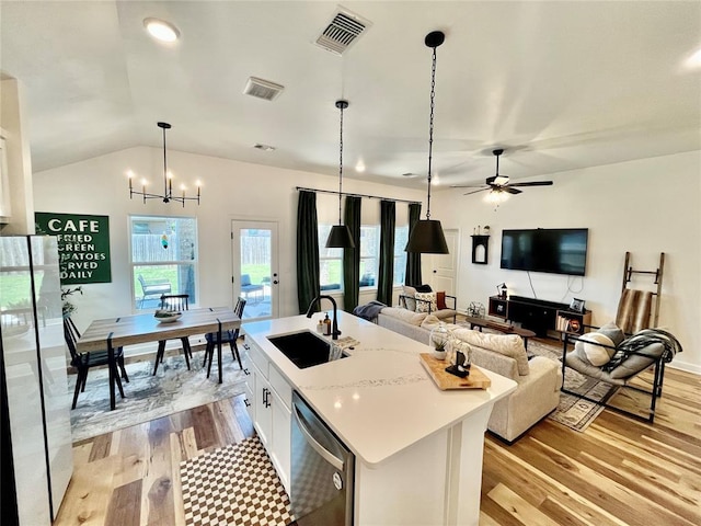 16340 Cold Fire Rd, Oklahoma City, OK 73170 - kitchen featuring dishwasher, freestanding refrigerator, a sink, light wood-type flooring, and lofted ceiling