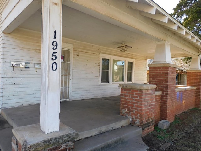 entrance to property featuring a porch and brick siding