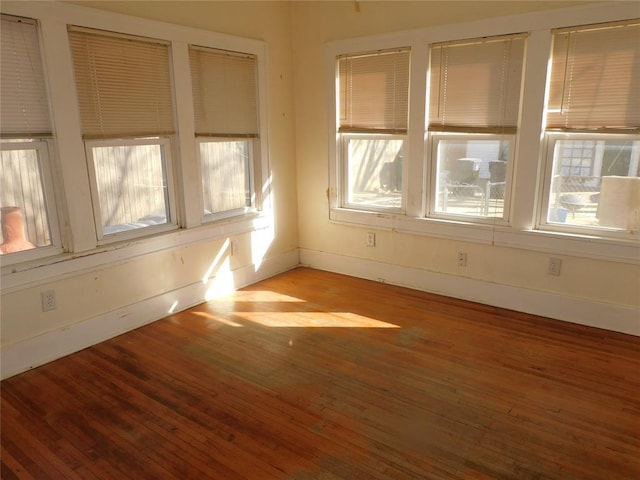 spare room featuring light wood-style flooring and baseboards