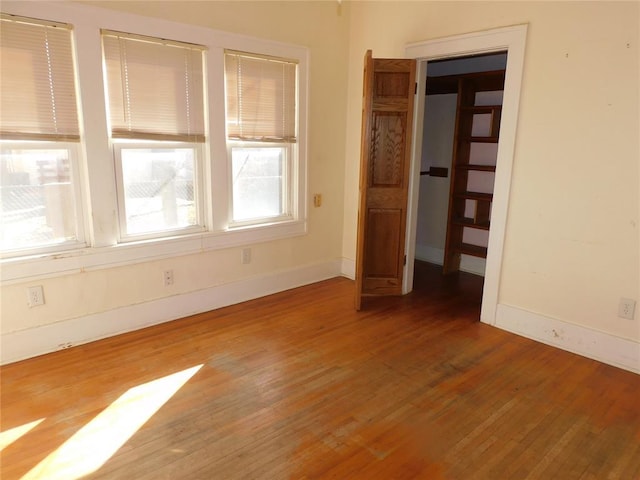 unfurnished bedroom with baseboards and wood finished floors
