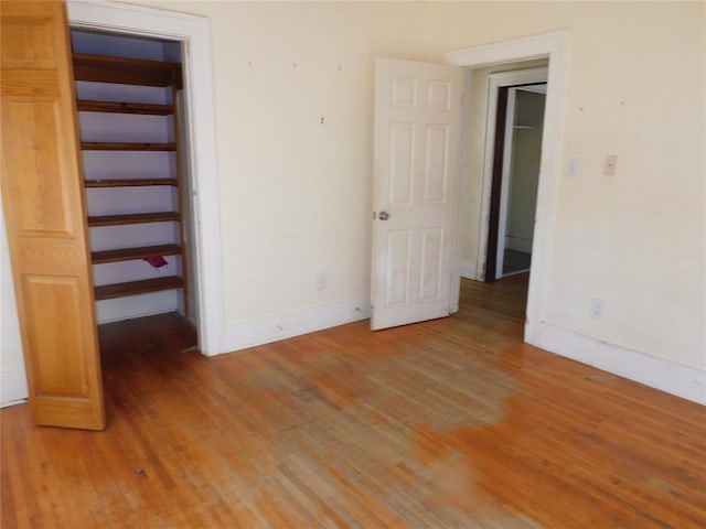 unfurnished bedroom with light wood-style floors and baseboards