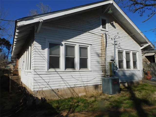 view of home's exterior featuring central AC and fence