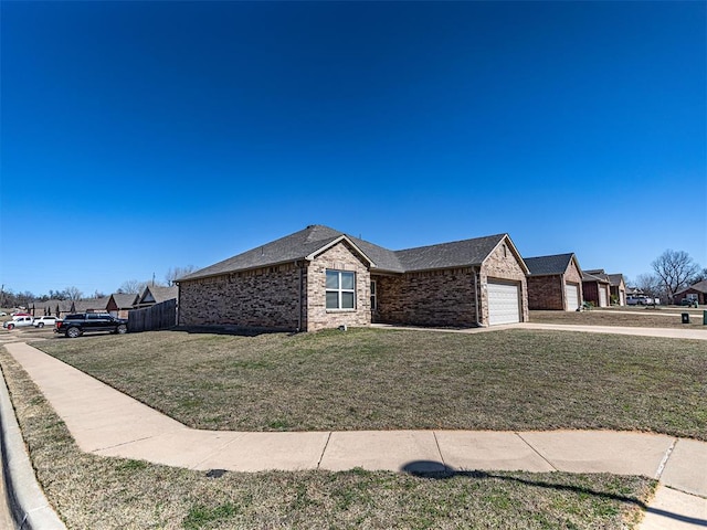 ranch-style home featuring brick siding, an attached garage, fence, a residential view, and a front lawn