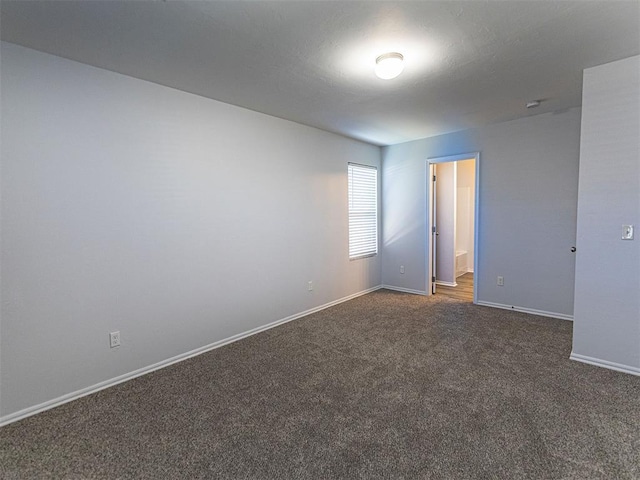 spare room with carpet flooring and baseboards