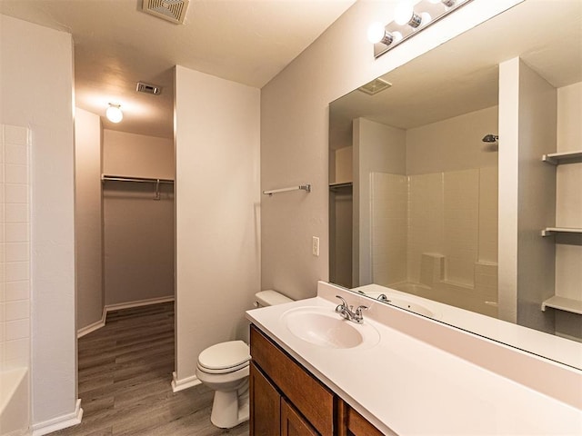 full bath featuring baseboards, visible vents, toilet, and wood finished floors