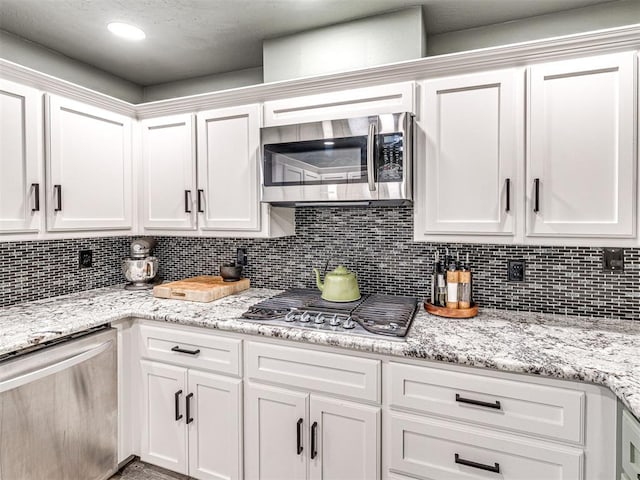 kitchen with stainless steel appliances and white cabinets