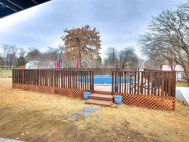 wooden deck with a fenced in pool