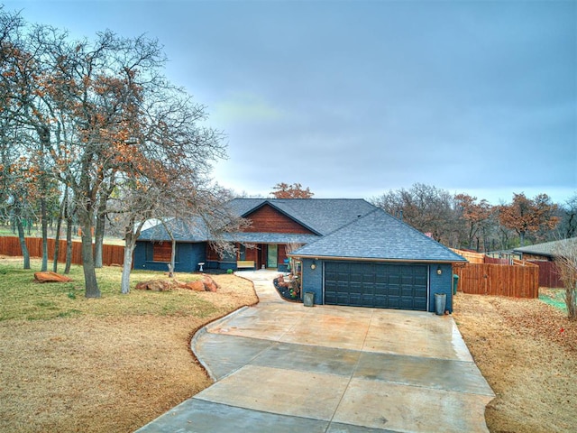 view of front of house featuring a front yard, concrete driveway, brick siding, and fence