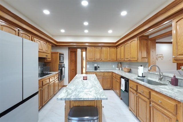 kitchen with black appliances, recessed lighting, a sink, and a center island