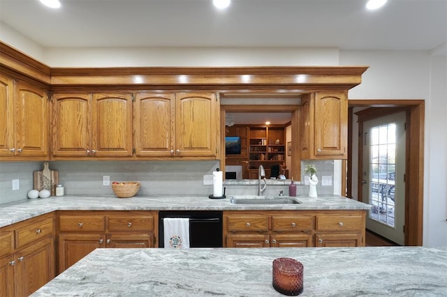 kitchen with a sink, brown cabinetry, and dishwasher