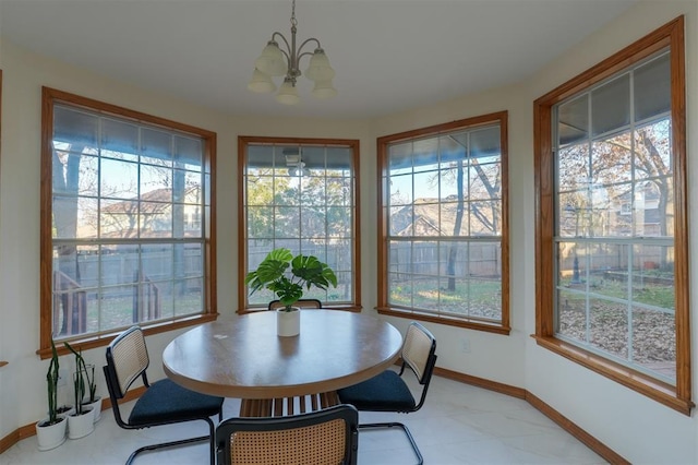 sunroom featuring a chandelier