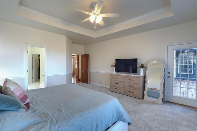 bedroom featuring crown molding, a raised ceiling, and light colored carpet