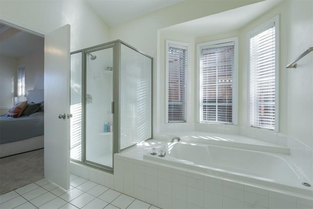 bathroom with a garden tub, ensuite bath, tile patterned flooring, and a shower stall