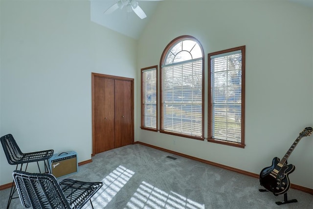 bedroom with high vaulted ceiling, a ceiling fan, visible vents, baseboards, and carpet