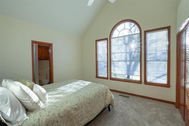 bedroom with light colored carpet, visible vents, a ceiling fan, high vaulted ceiling, and baseboards