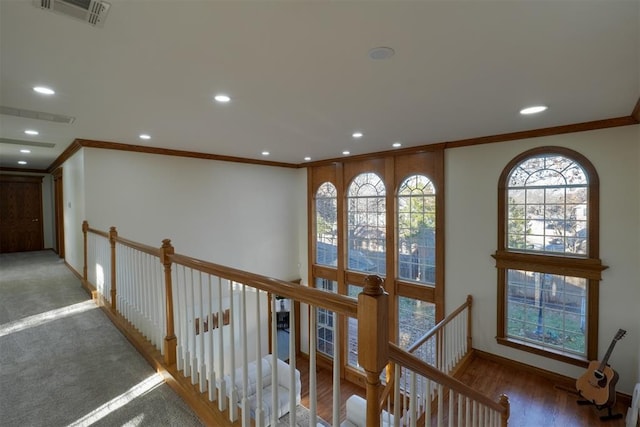 hall with recessed lighting, visible vents, crown molding, and an upstairs landing