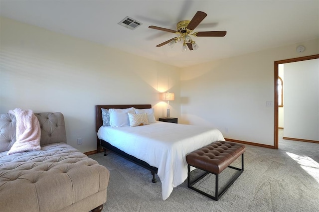 carpeted bedroom with ceiling fan, visible vents, and baseboards