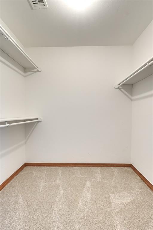 walk in closet featuring carpet and visible vents