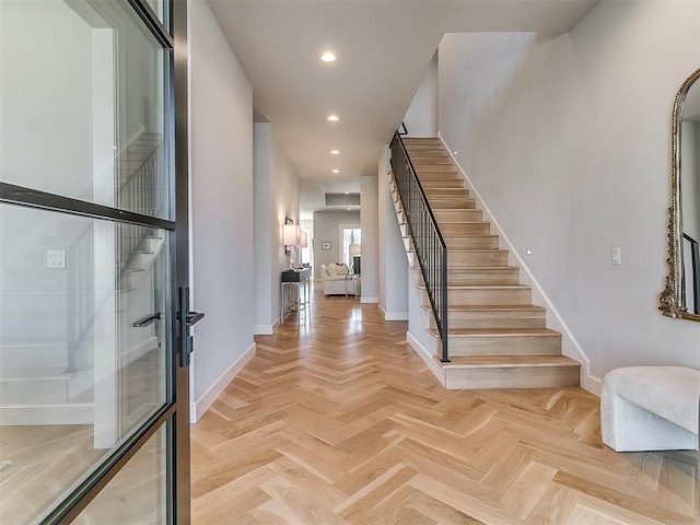 foyer with stairway, recessed lighting, and baseboards