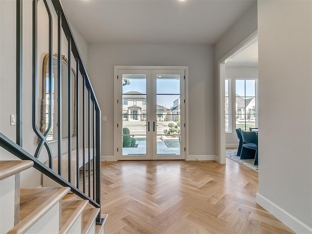 entrance foyer featuring a wealth of natural light, french doors, and stairs