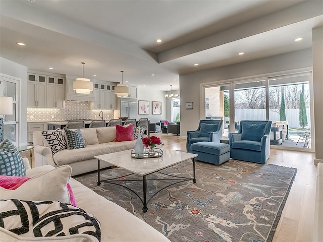 living area with recessed lighting and light wood-style floors