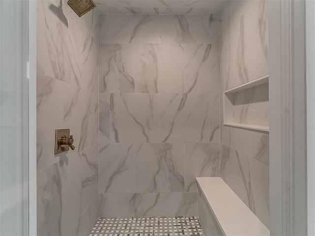 bathroom featuring a tile shower