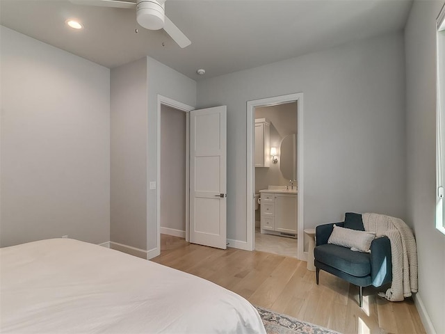 bedroom featuring baseboards, recessed lighting, ceiling fan, ensuite bathroom, and light wood-type flooring