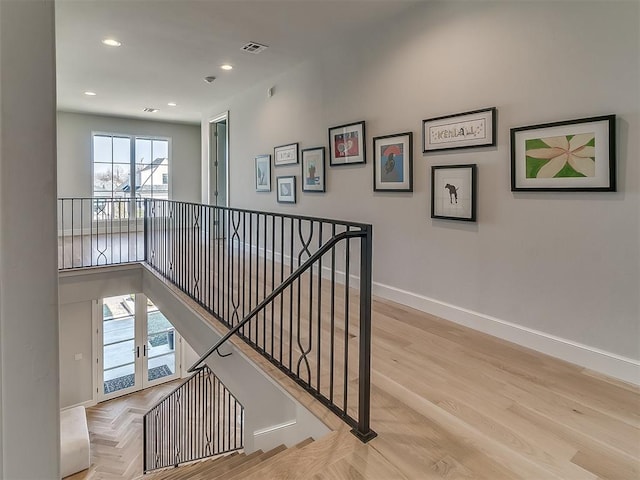 stairway featuring visible vents, baseboards, recessed lighting, parquet flooring, and french doors