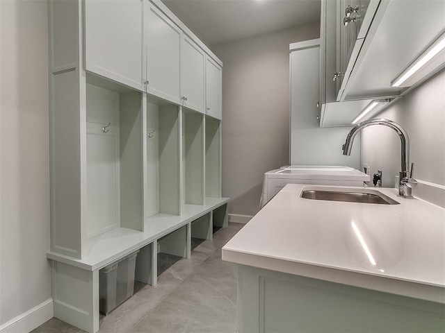 mudroom with a sink and baseboards