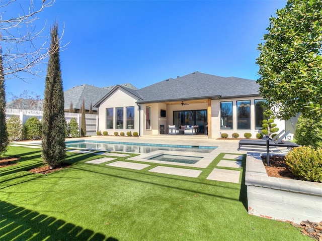 rear view of house featuring a lawn, a ceiling fan, a fenced backyard, a shingled roof, and an in ground hot tub