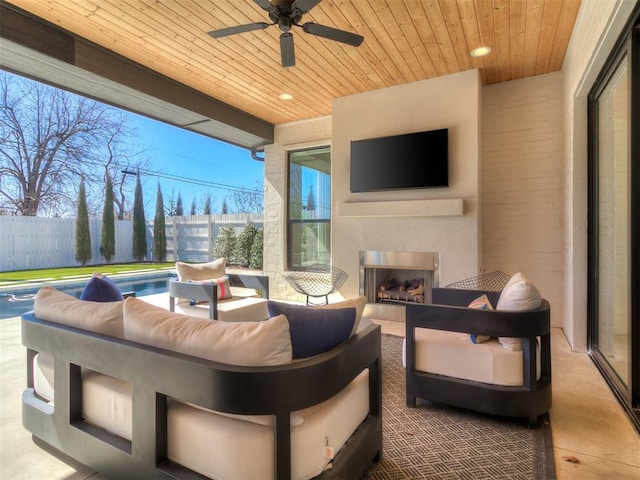 view of patio / terrace with an outdoor living space with a fireplace, a fenced in pool, ceiling fan, and fence