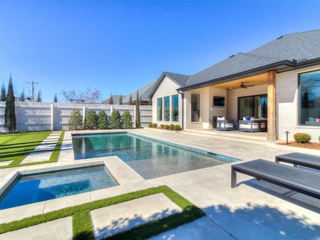 view of swimming pool with a ceiling fan, an in ground hot tub, a fenced backyard, outdoor lounge area, and a patio area