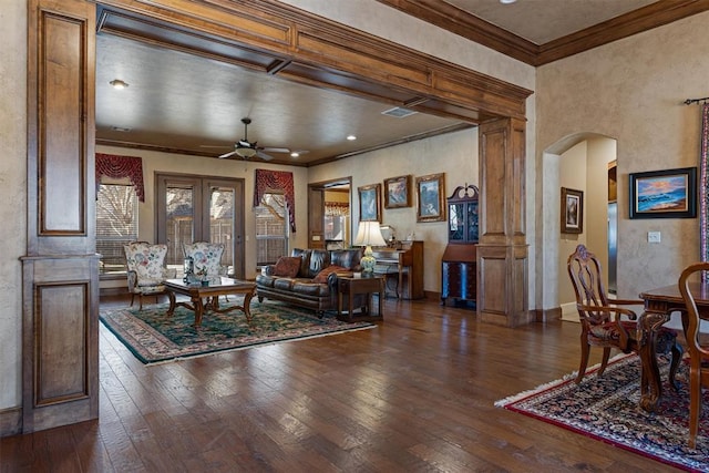 living room featuring a ceiling fan, arched walkways, wood-type flooring, and crown molding