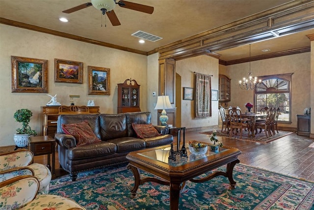 living room featuring visible vents, wood-type flooring, ornamental molding, ceiling fan with notable chandelier, and recessed lighting