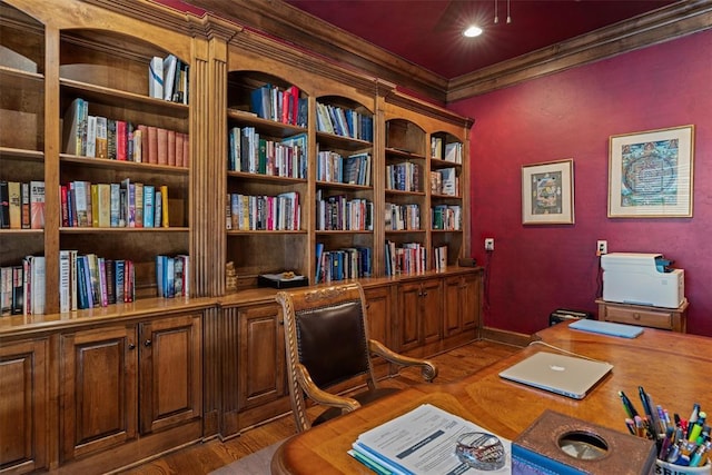 home office with crown molding and wood finished floors