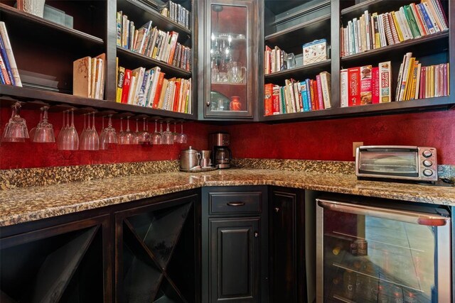 interior space featuring a bar, wine cooler, and a toaster