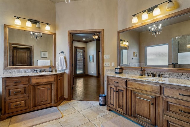 full bathroom featuring two vanities, a sink, and tile patterned floors