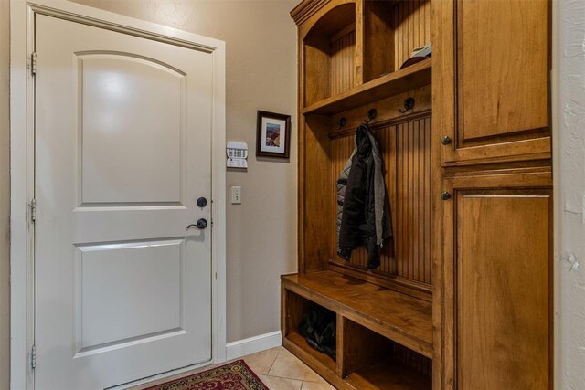 mudroom with baseboards and light tile patterned floors