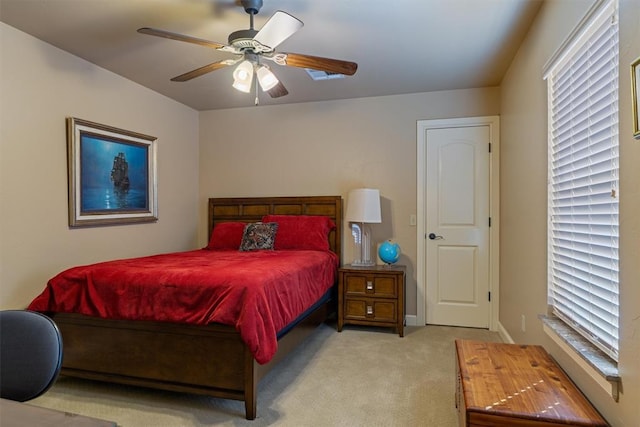 bedroom with light carpet, ceiling fan, and baseboards