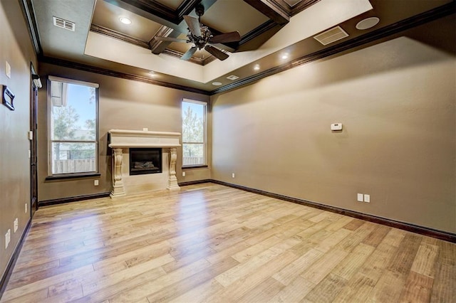 unfurnished living room with coffered ceiling, wood finished floors, visible vents, ornamental molding, and a glass covered fireplace