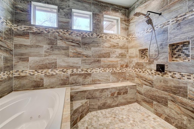 bathroom with a whirlpool tub and tiled shower