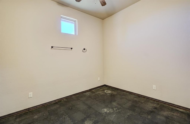 unfurnished room featuring ceiling fan and baseboards