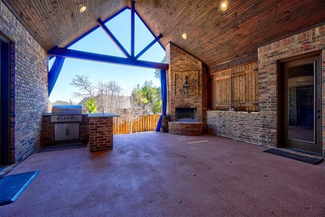 view of patio / terrace featuring a fireplace, grilling area, area for grilling, and fence